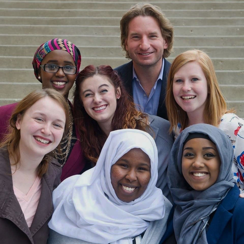 Dean Phillips poses with young women.