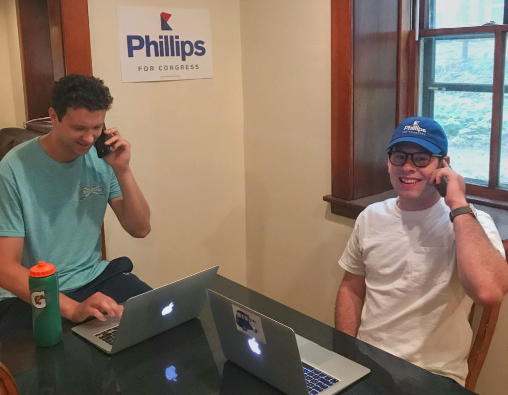 Luke phone banks with a volunteer