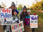 Moms and daughters pose with homemade Phillips campaign signs.